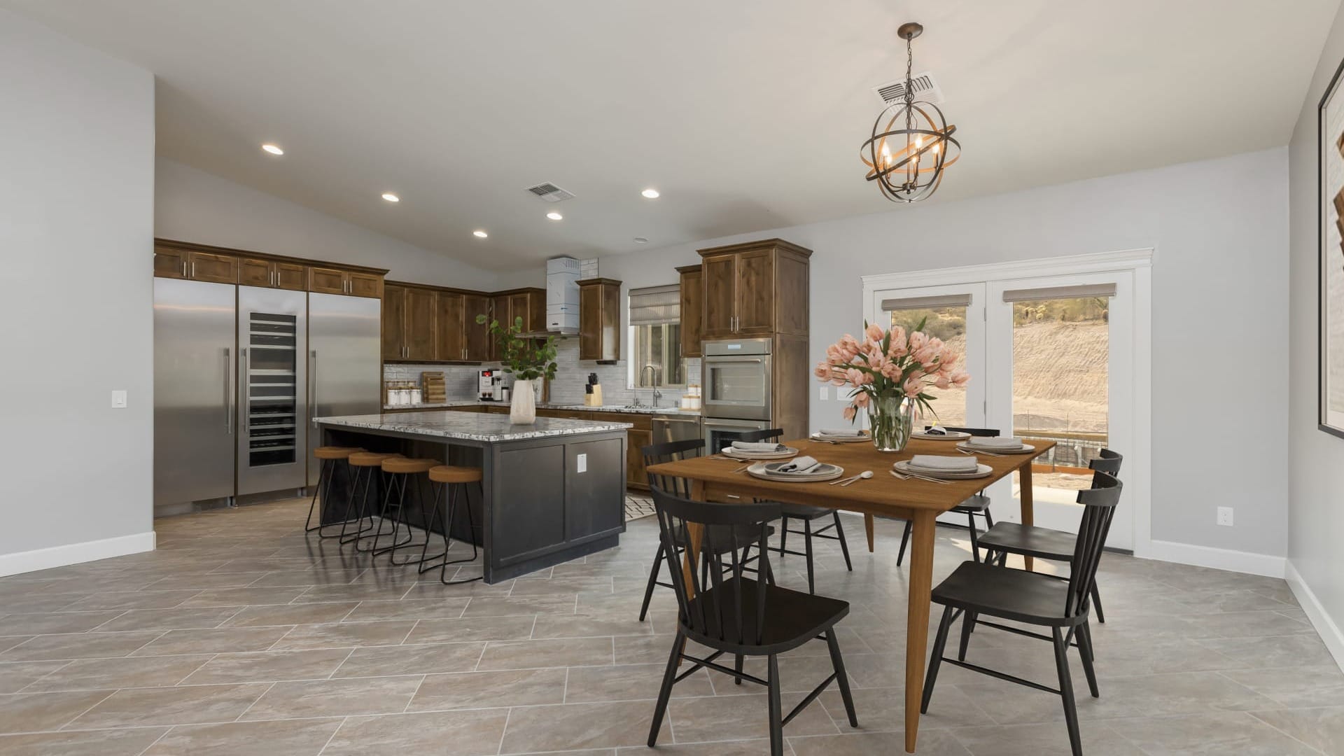 A kitchen and dining room combined in a house with darker colored furniture
