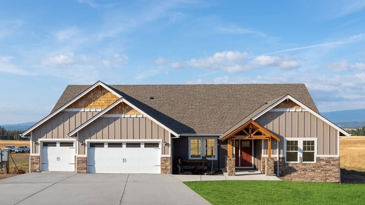 A house with tan siding and wooden accents