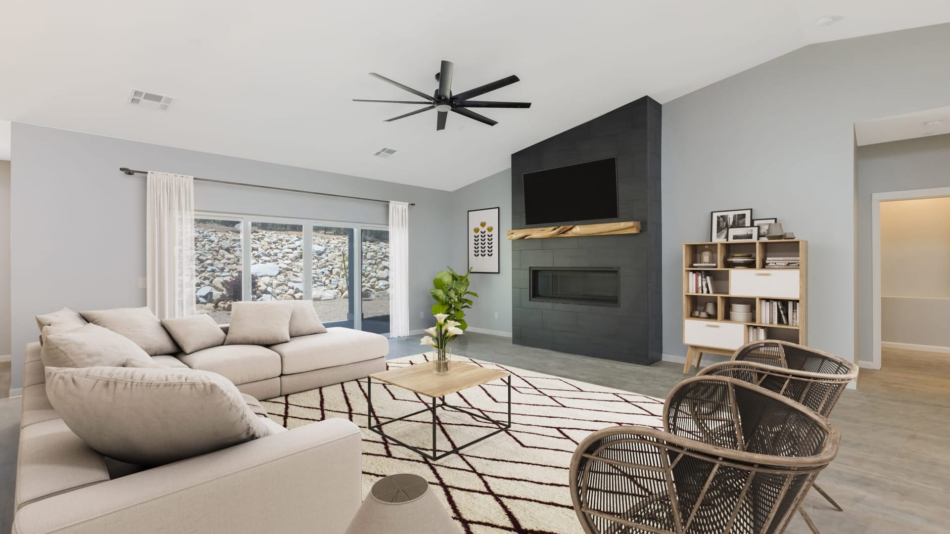 A living room with a couch and a fireplace with a TV on the hearth