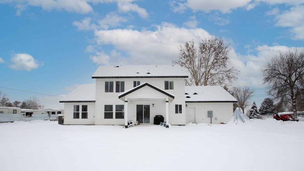 A white house with snow all around