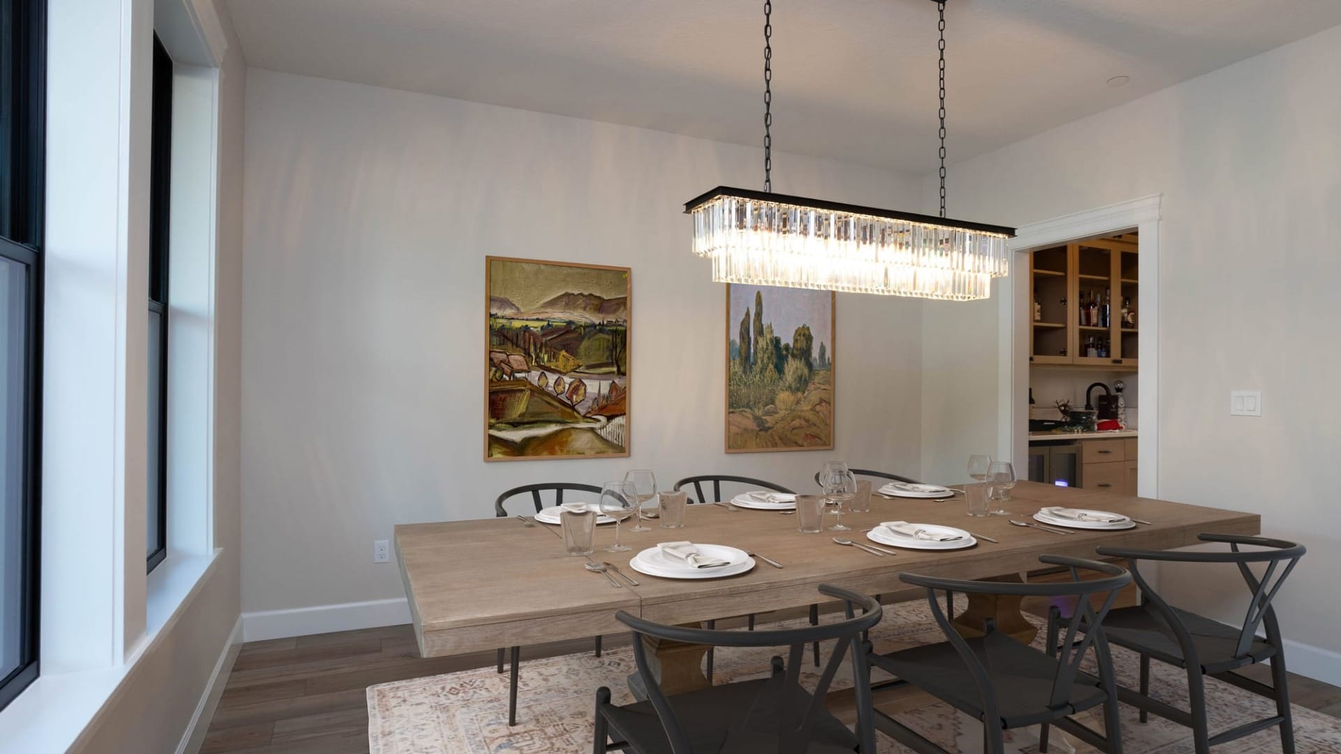 A dining room with a table and chairs around it