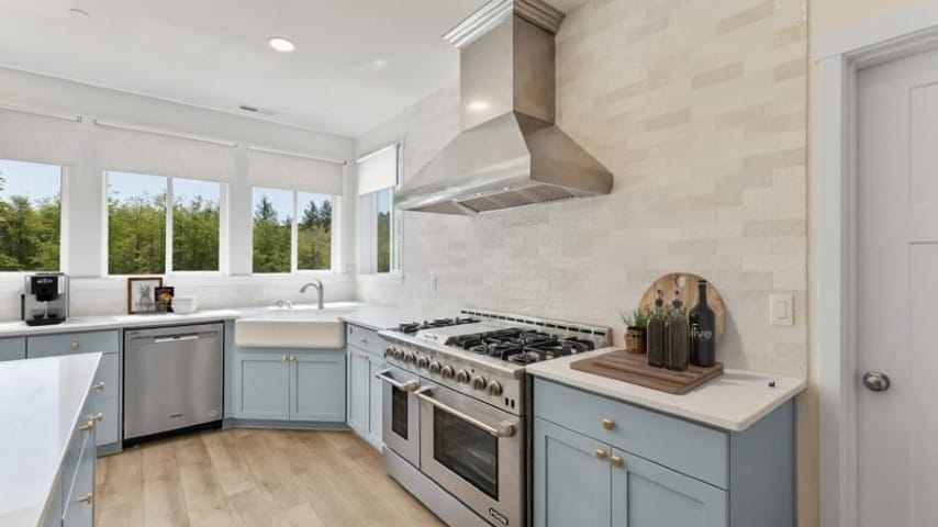 A kitchen with a stove next to blue cabinets