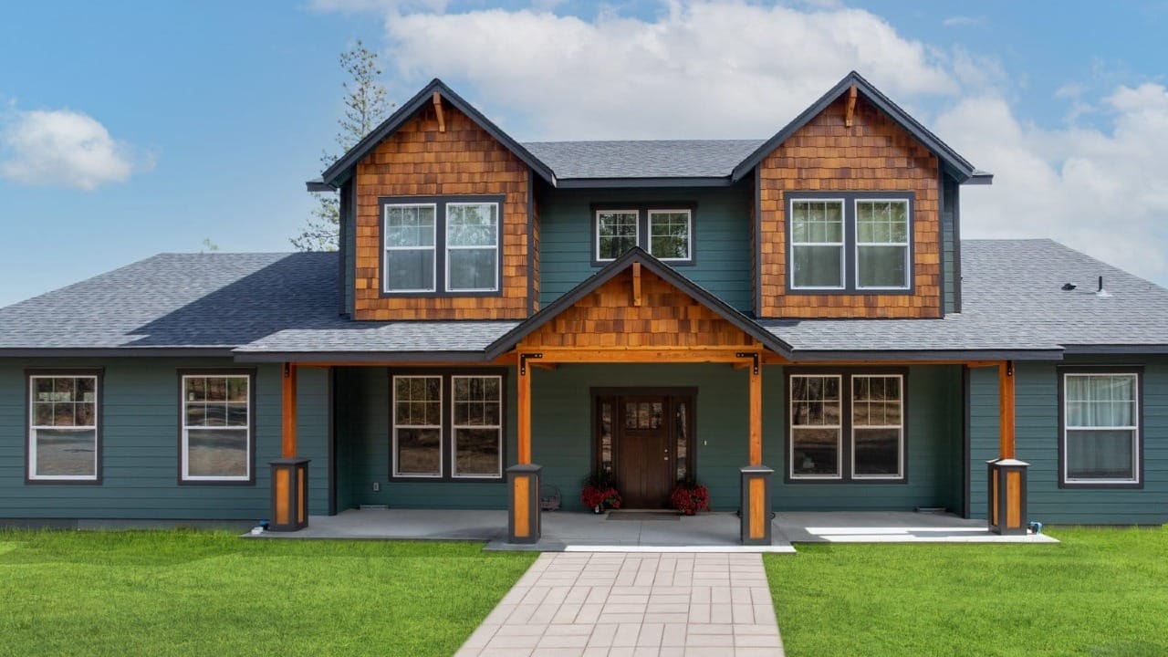 A house with green siding and wooden accents
