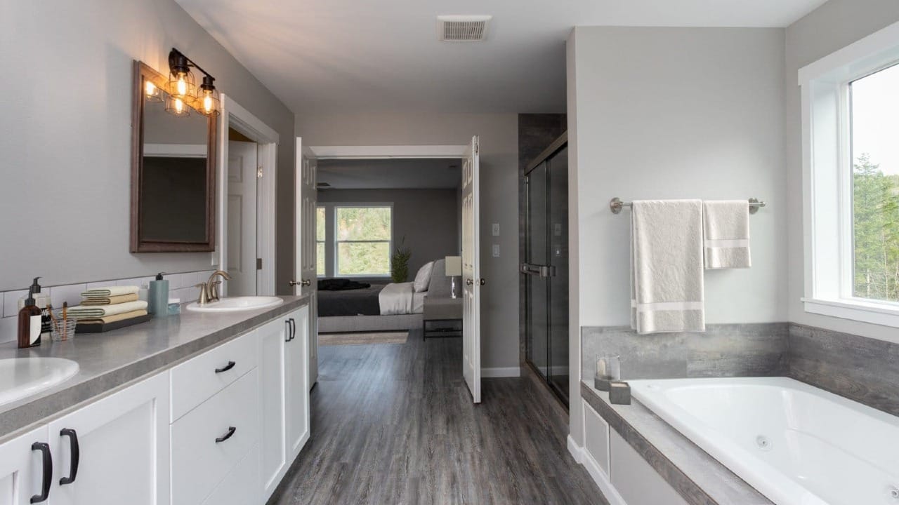 A bathroom with a view onto the master bedroom