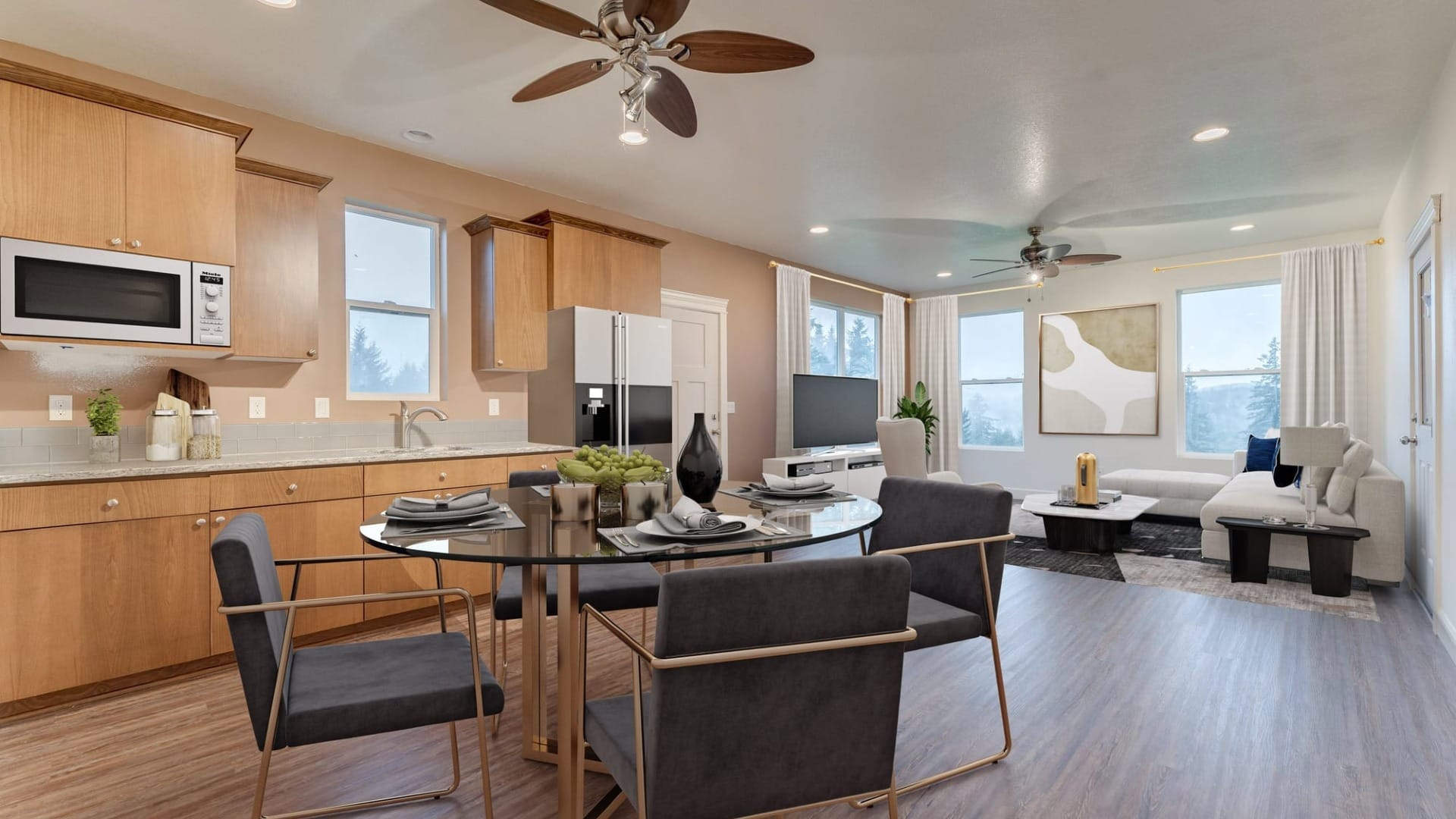 A room with a living room, kitchen, and a table