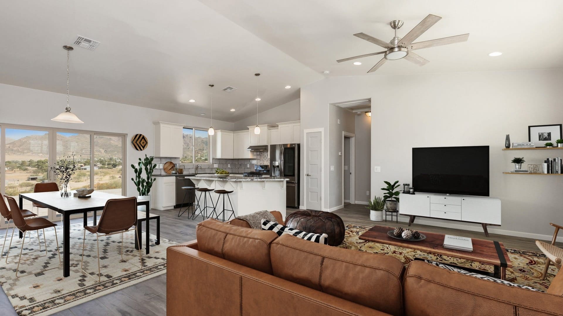 Bright open concept kitchen and living area with white cabinetry, kitchen island seating, dining space, and modern finishes in a custom home.