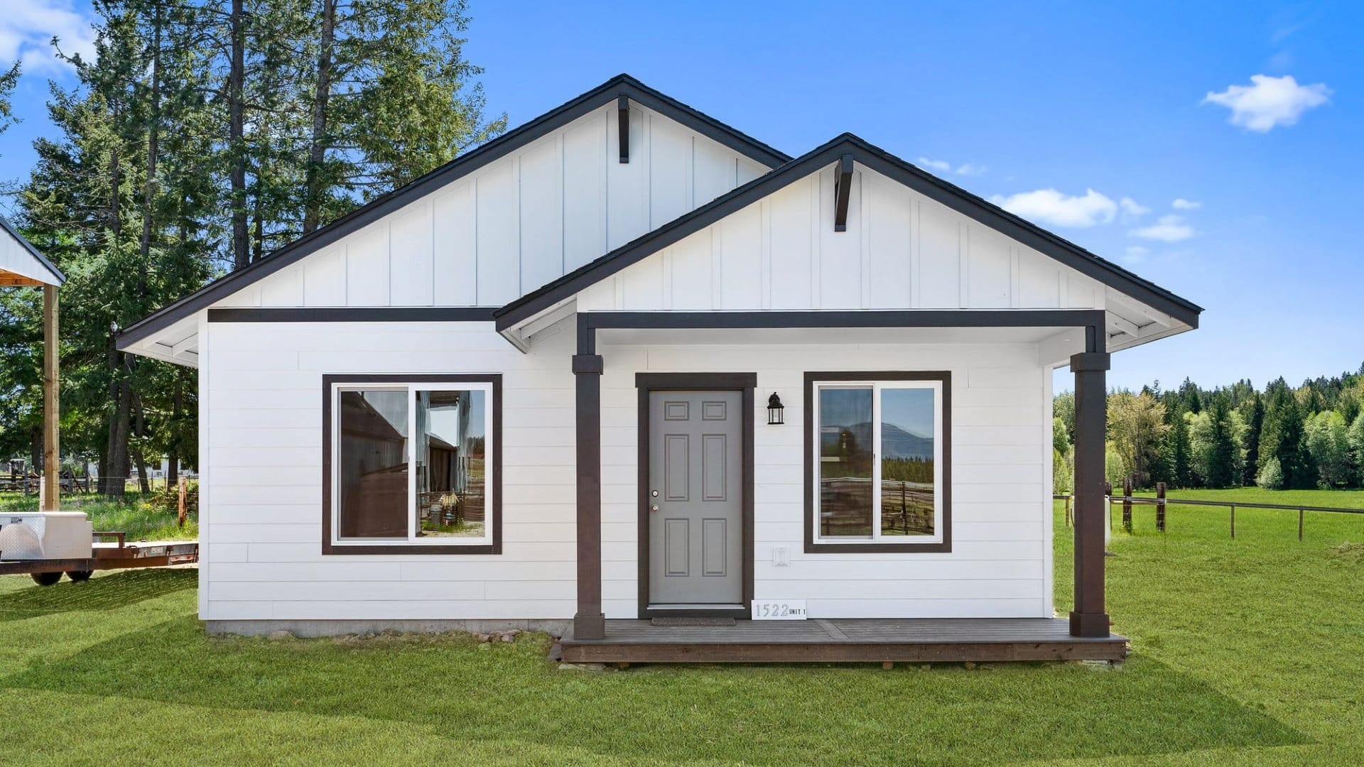 A small white house with brown frames