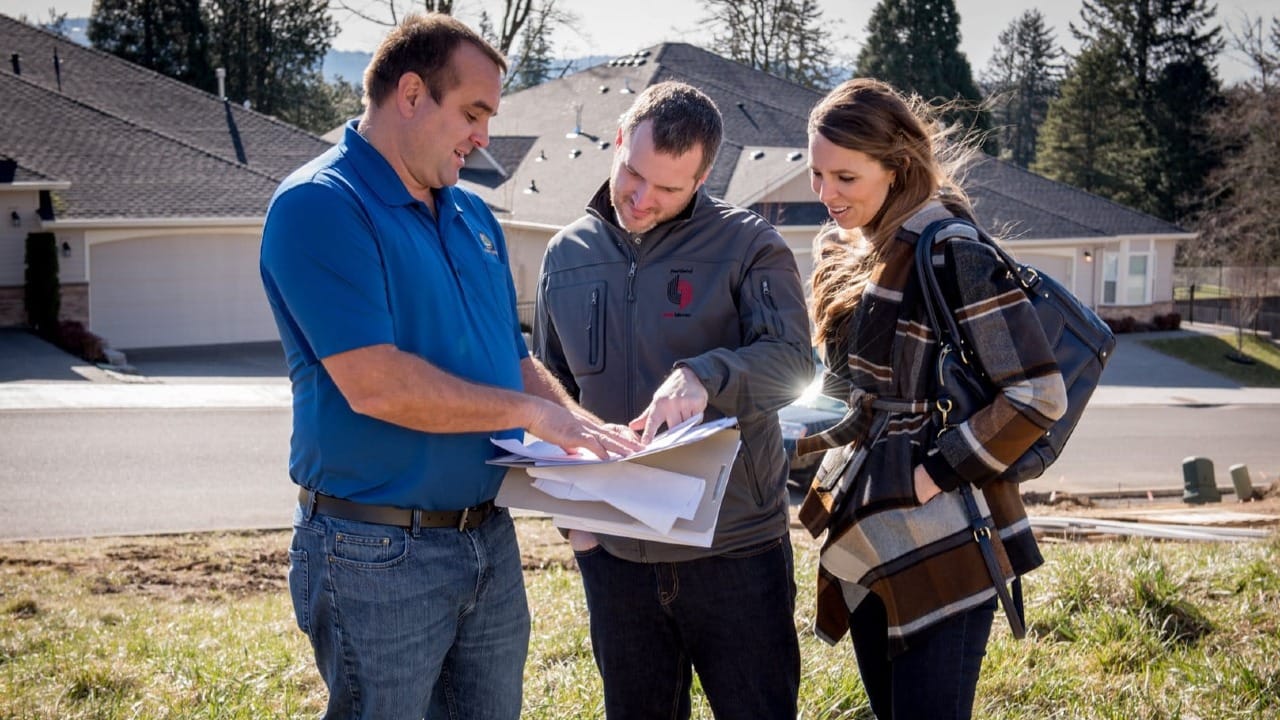 A man showing papers to a couple