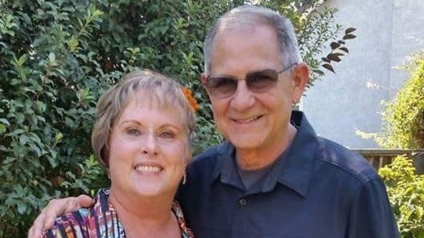 Chapman couple holding a rose bouquet