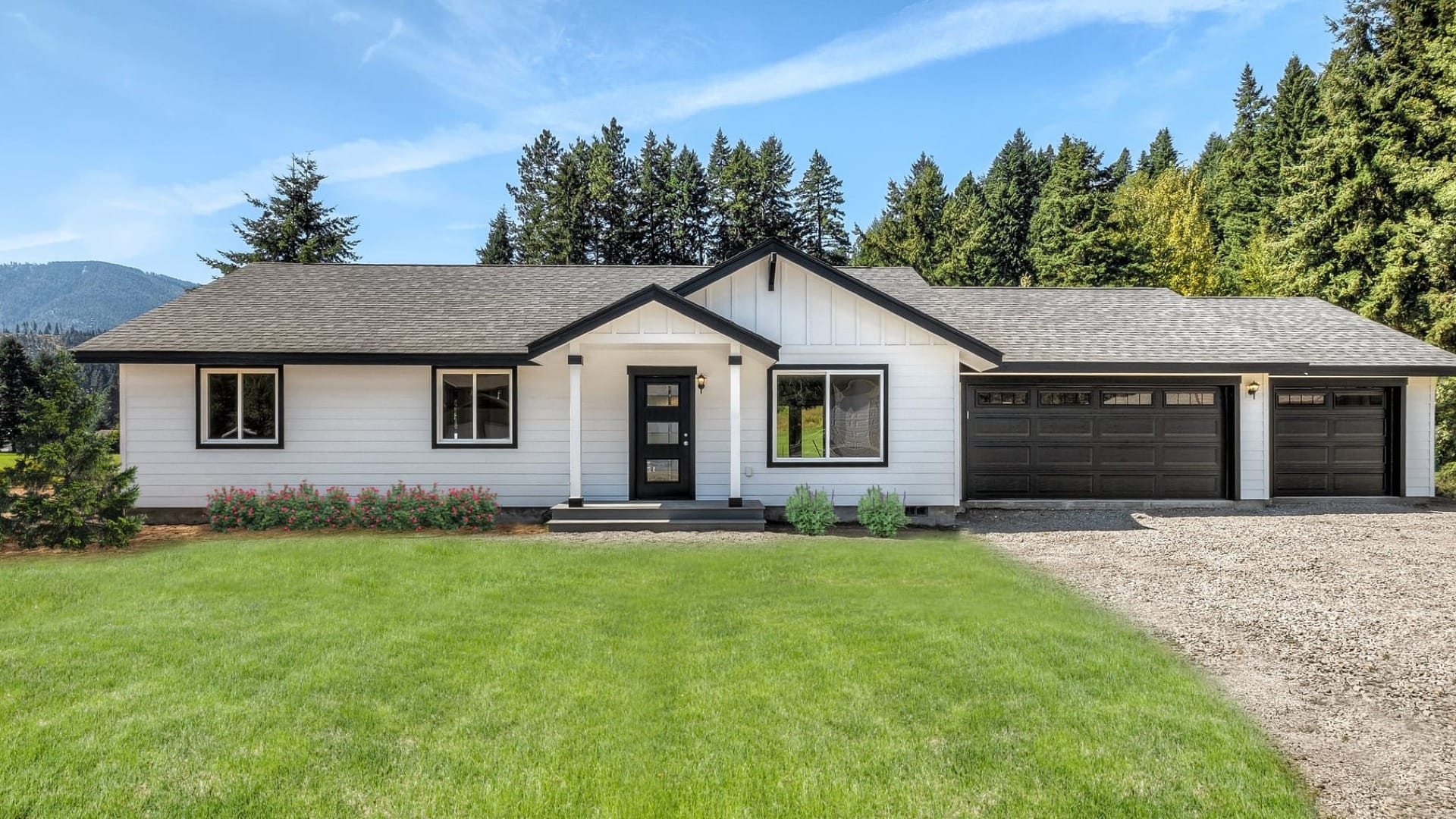 A white house in front of a large hill