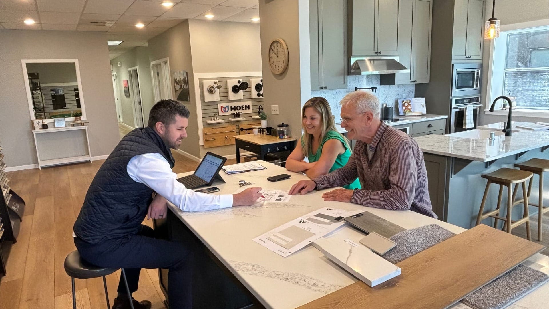 A couple talking to a man about a new house they need built