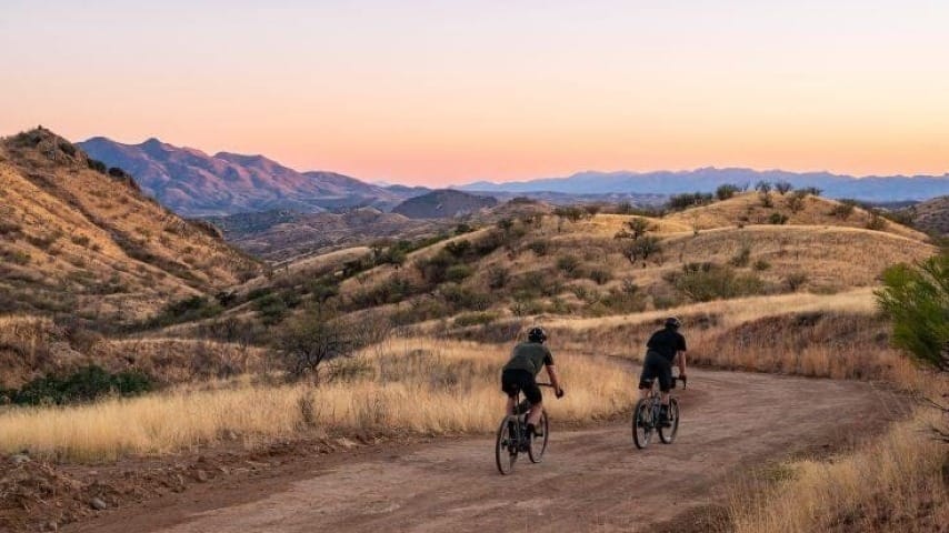Two bikers driving down a path in Arizona