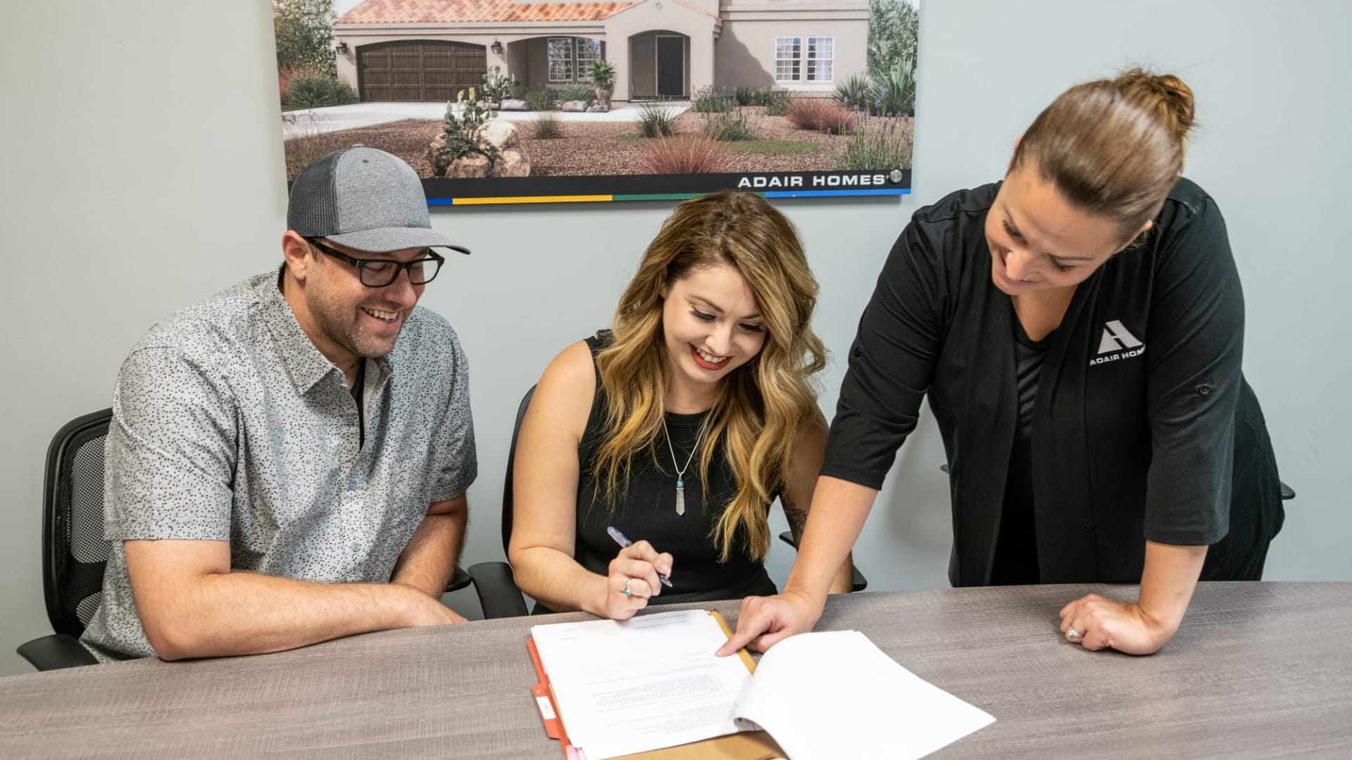 A couple sigining some papers