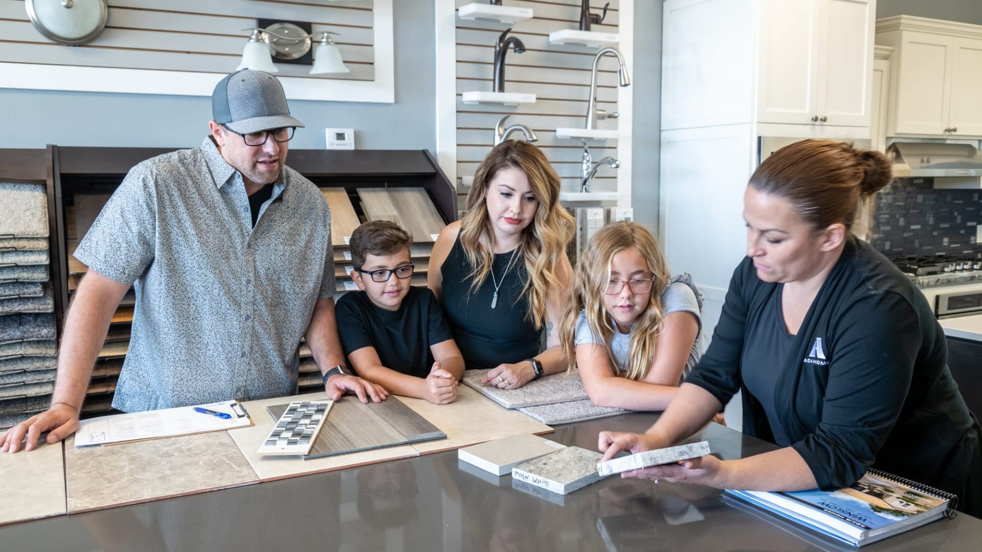 Family looking at granite for countertops in their custom home build