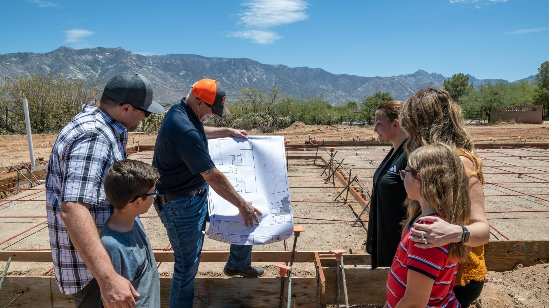 A family looking at the blueprints of their house