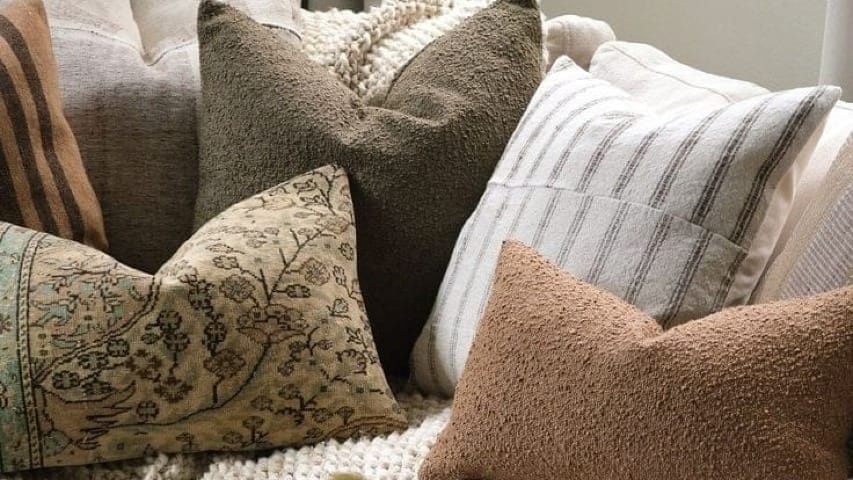 A couch with a bunch of fall decorations on it