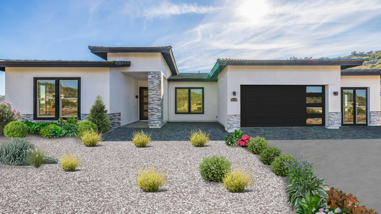 A house with Stuco siding in front of a gravel garden
