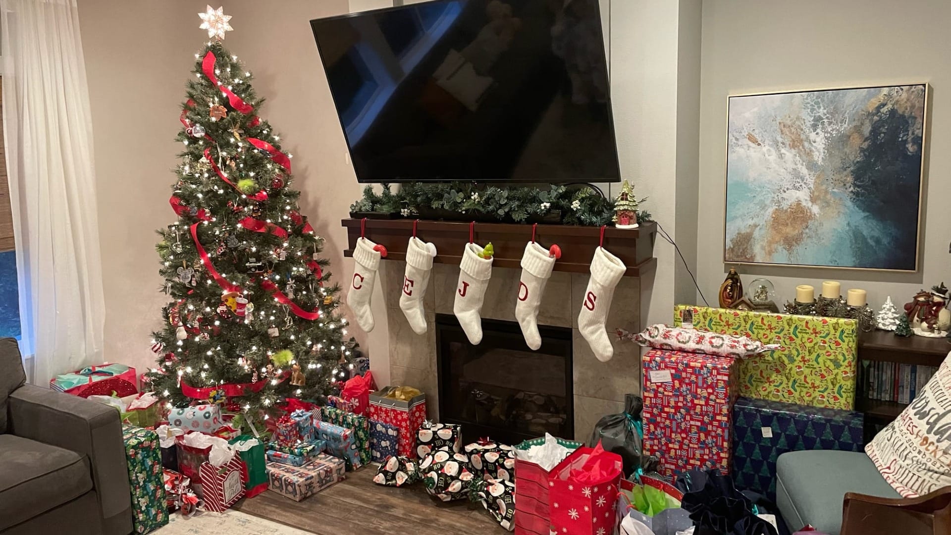 A TV on a hearth in a living room with christmas decorations