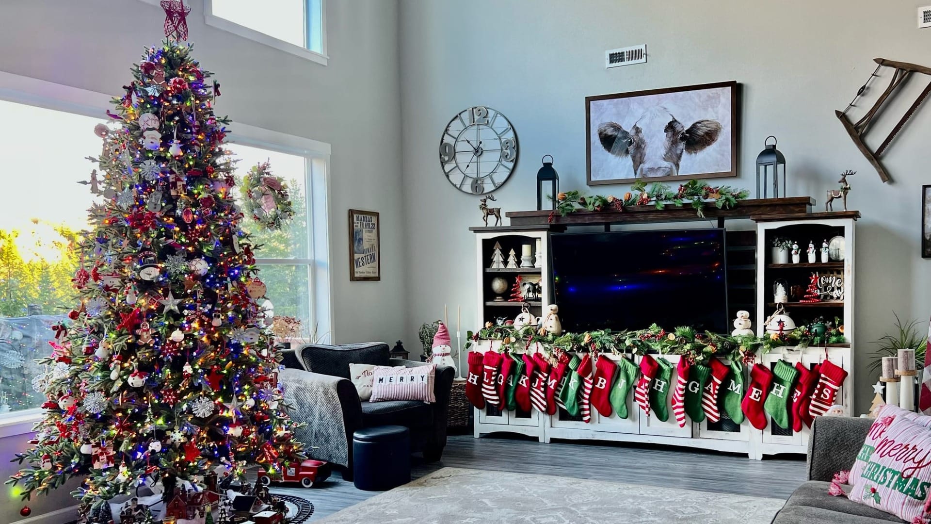 A living room with a giant christmas tree in it