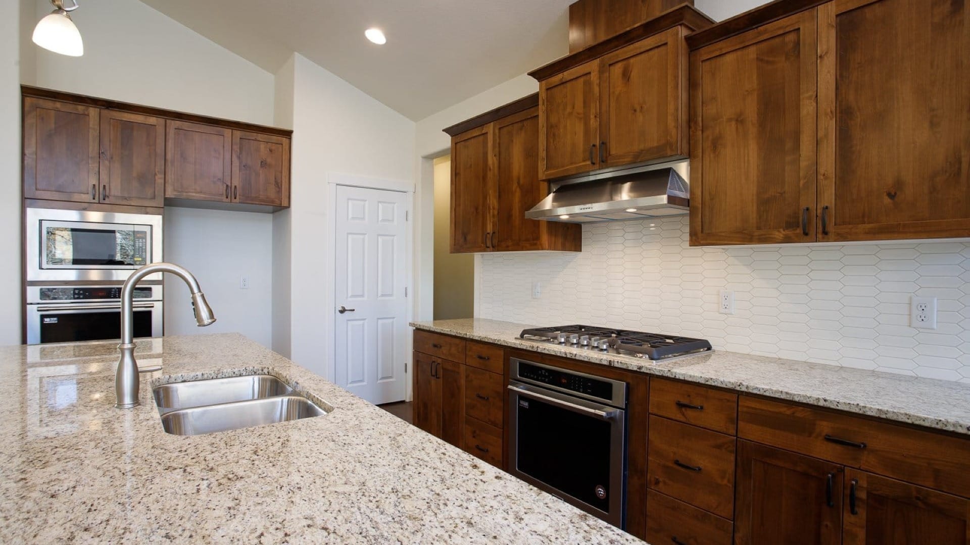 Kitchen close up of the tile island and kitchen appliences around it