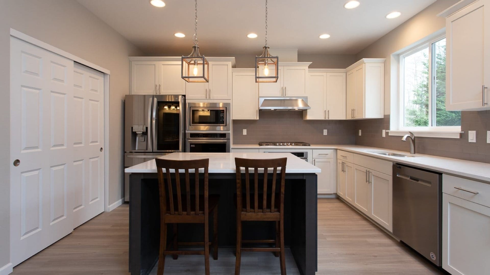 Modern style main kitchen with white cabinets and countertops