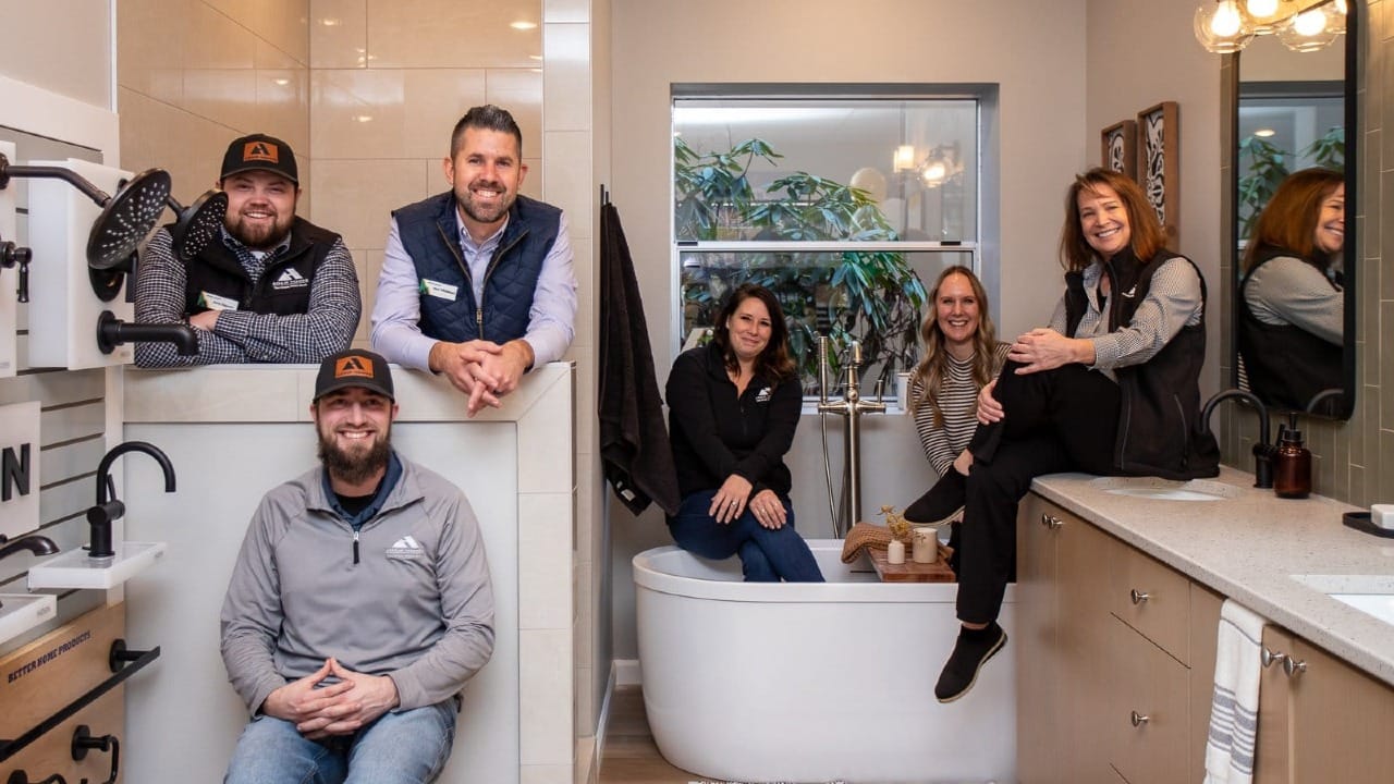People all sitting in a newly built bathroom