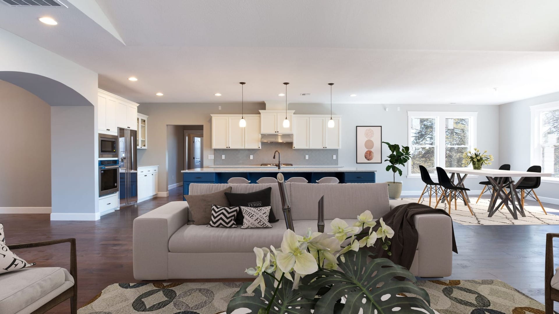 A living room with a kitchen behind it