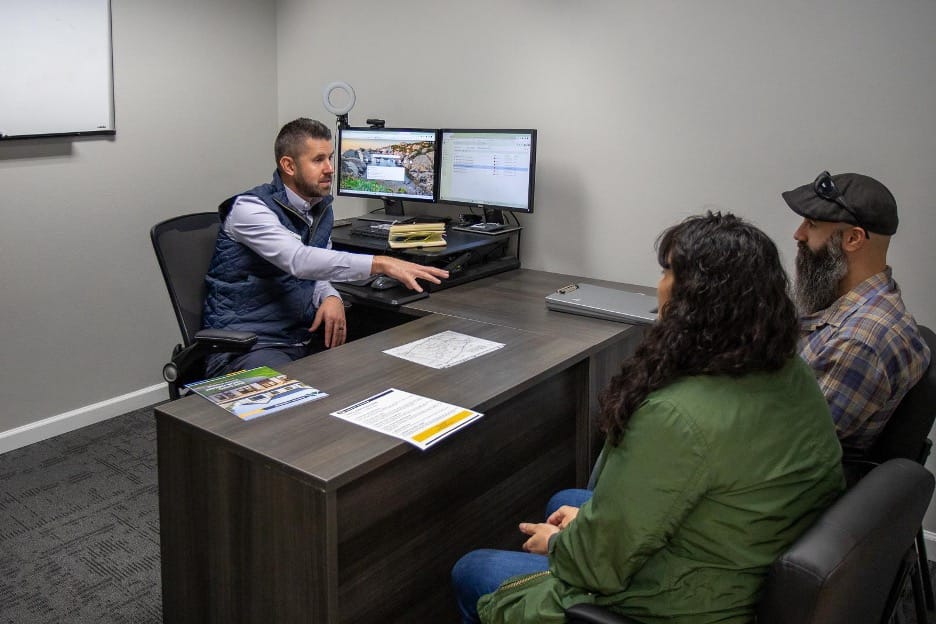 husband and wife talking with Adair home consultant about their options for their new home
