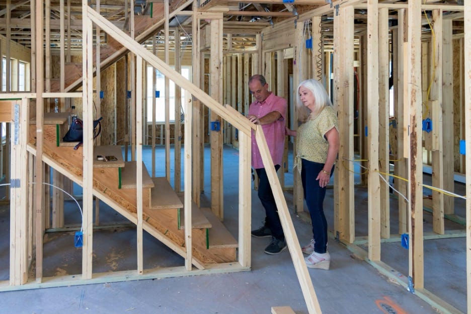 husband and wife inside their soon to be new home as it is being constructed by Adair Homes