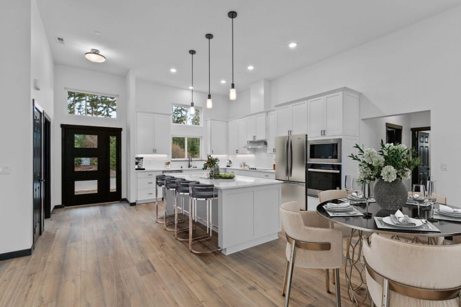 inside view of a white kitchen and dining room designed by Adair Homes