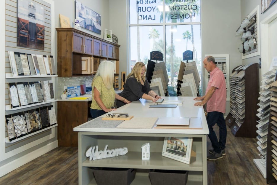 husband and wife picking out colors and designs with Adair Homes team in the store
