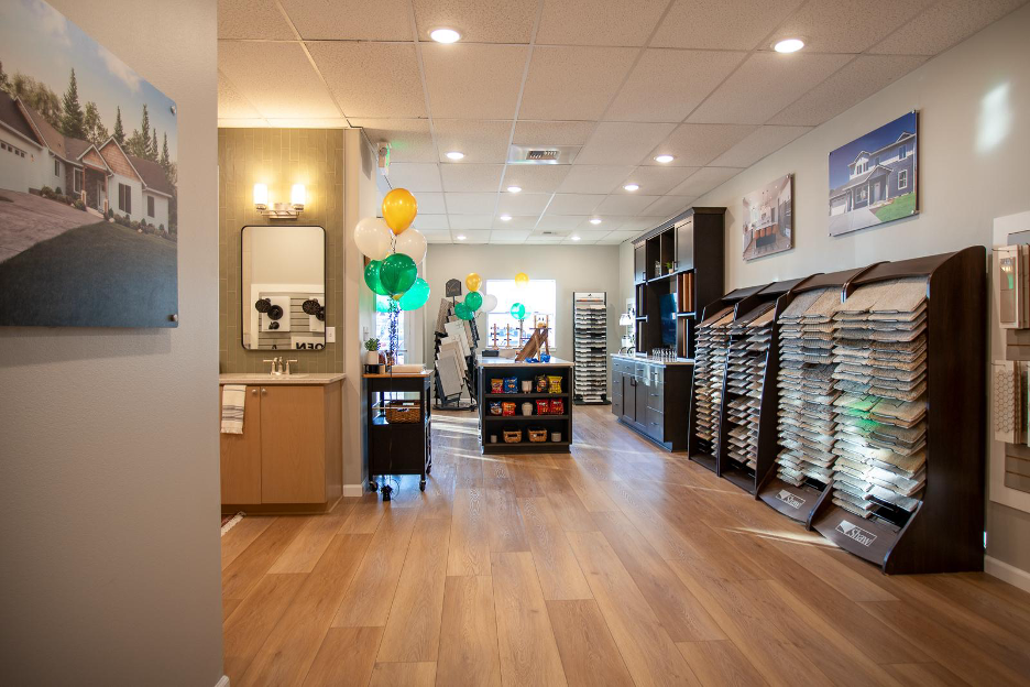 Adair Homes design center featuring flooring samples, lighting displays, and product options for customizing a new home.