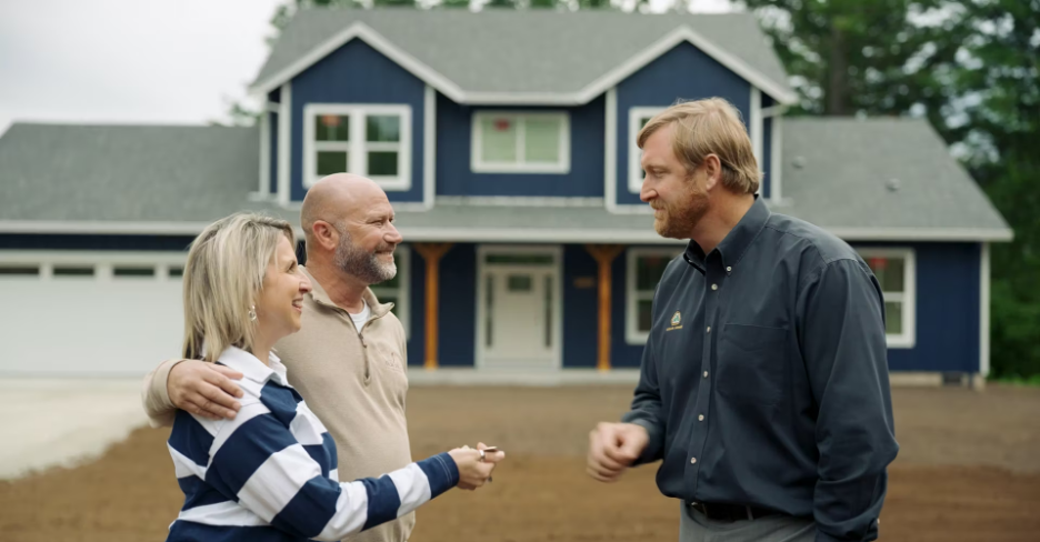 Happy homeowners receiving keys in front of their newly completed custom home, celebrating the build process with trusted custom home builders Spokane homeowners recommend