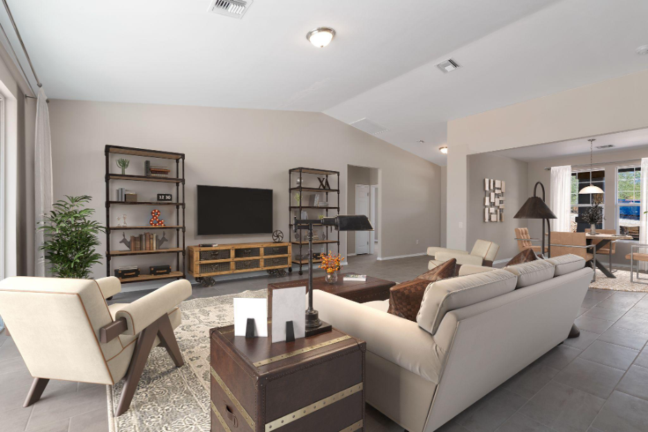 Spacious open-concept living room with neutral tones, modern furniture, tile flooring, and natural light flowing through large windows and adjoining dining area.