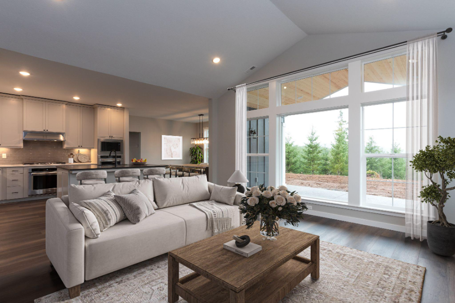 Modern open-concept living room and kitchen with vaulted ceilings, large windows, neutral tones, and views of the outdoors—designed for natural light and spacious living.