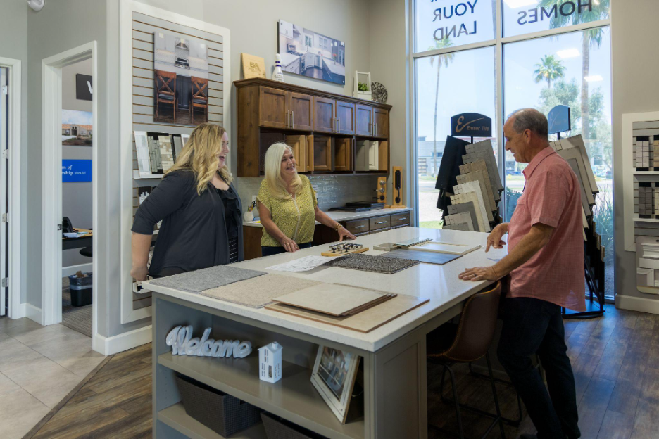 Homeowners meeting with home builders in Phoenix to review flooring, countertops, and finish selections at a design center