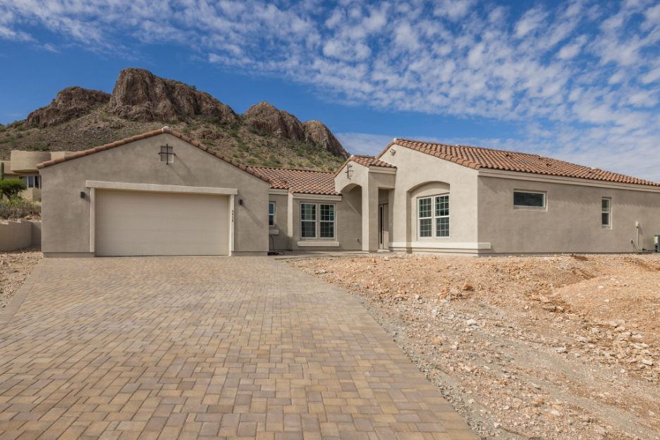 Completed custom Southwest-style home built in Phoenix with stucco exterior, tile roof, and mountain views
