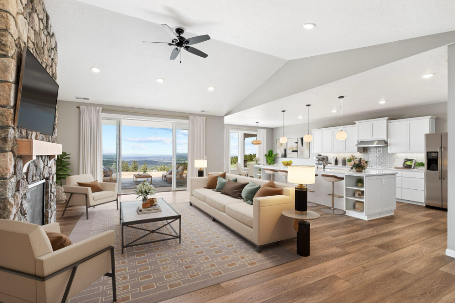Open-concept living room and kitchen in a custom home with large windows, vaulted ceilings, and outdoor views