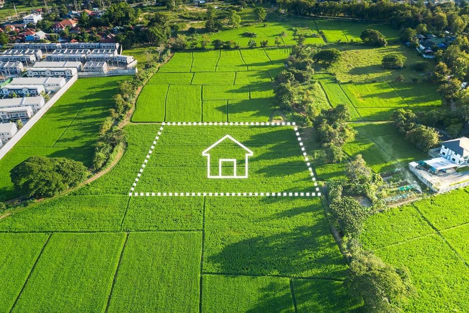 Aerial view of green farmland with a marked home site outlined, representing on your lot custom home building.