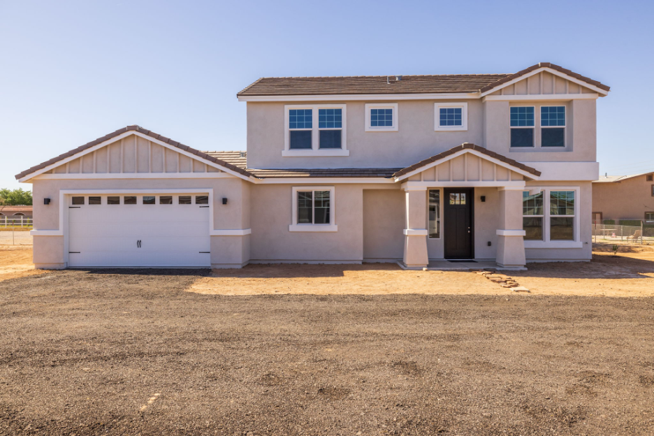 Two story suburban home with attached garage and fresh exterior finish on a large lot.