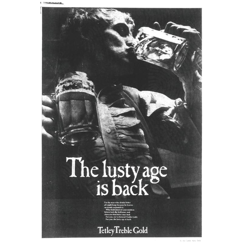 A 1970s advert for Tetley Treble Gold, a black and white photo of a man in a frilled shirt drinking from one tankard full of beer while holding another in his other hand
