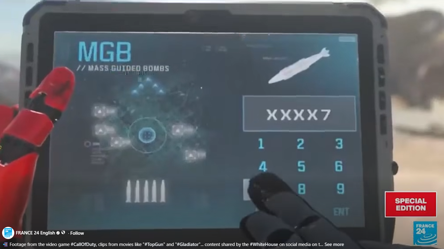 A screenshot from France 24's coverage showing a tablet screen displaying what appears to be a Call of Duty video game interface, with the text "MGB — Mass Guided Bombs" and a targeting display. A chyron at the bottom of the frame reads: "Footage from the video game #CallOfDuty, clips from movies like #TopGun and #Gladiator content shared by the #WhiteHouse on social media."