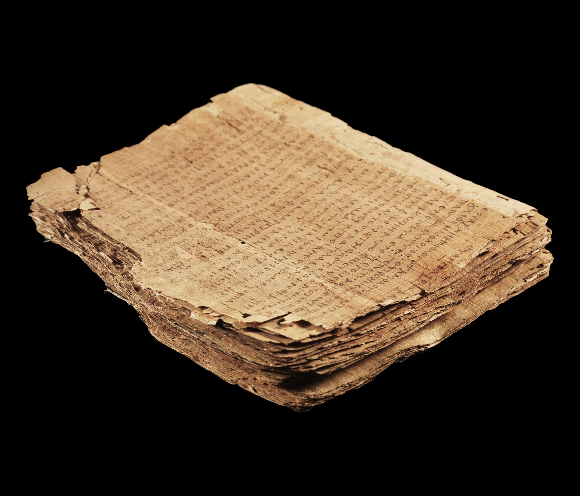 A fragment of an ancient papyrus codex page covered in dense Greek majuscule script, browned and cracked with age, the text running in a single column.