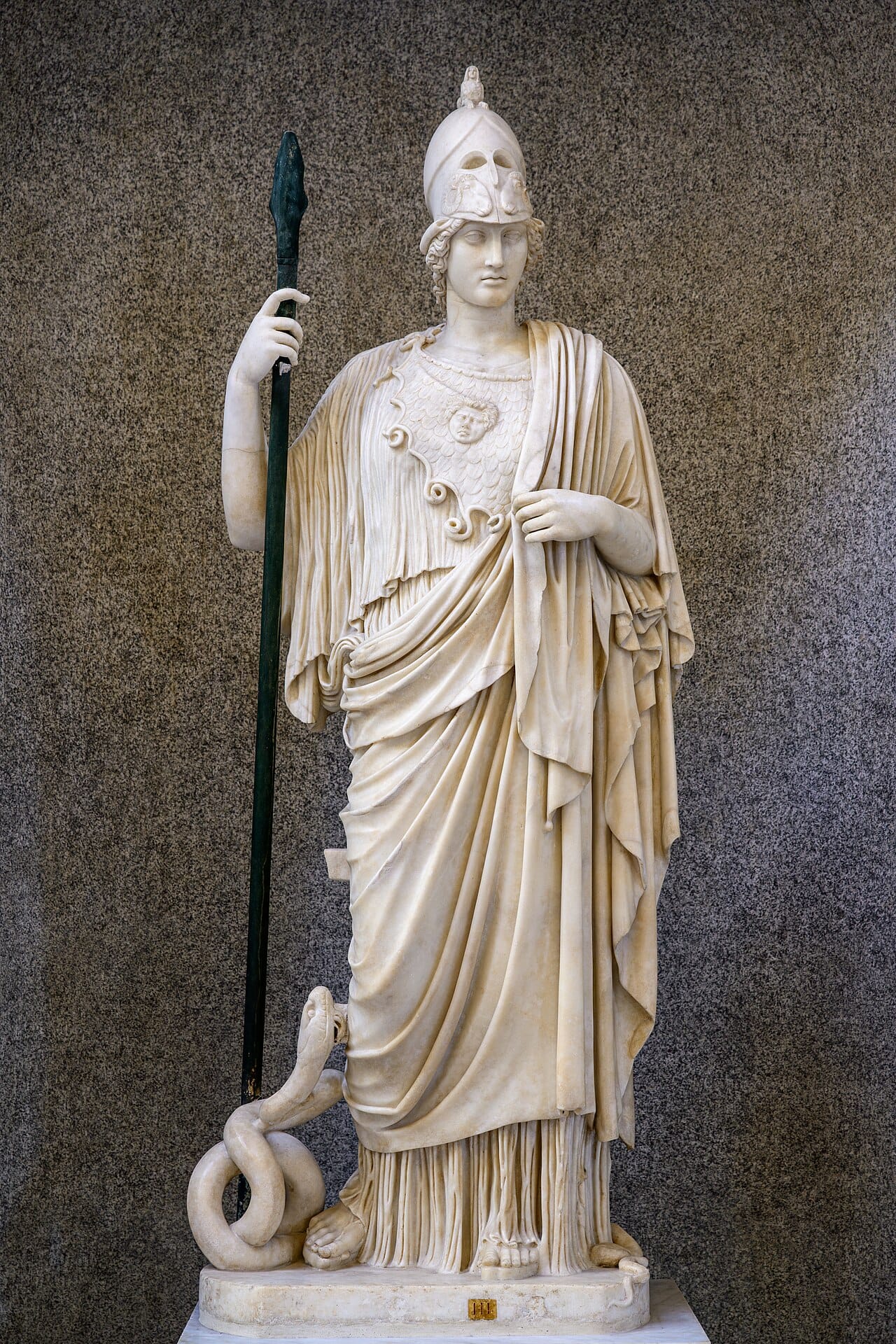 A marble statue of Pallas Athena, holding spear with snake at her feet. 