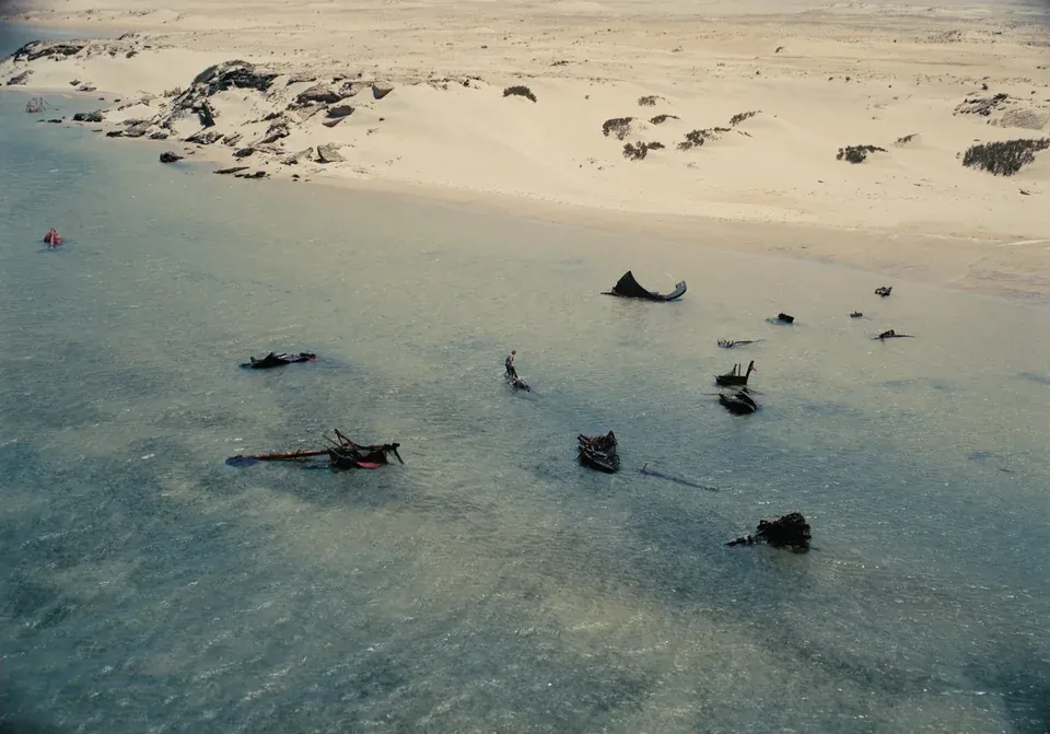 Wide angle shot of Matt Damon as Odysseus in the shallows of Ogygia.