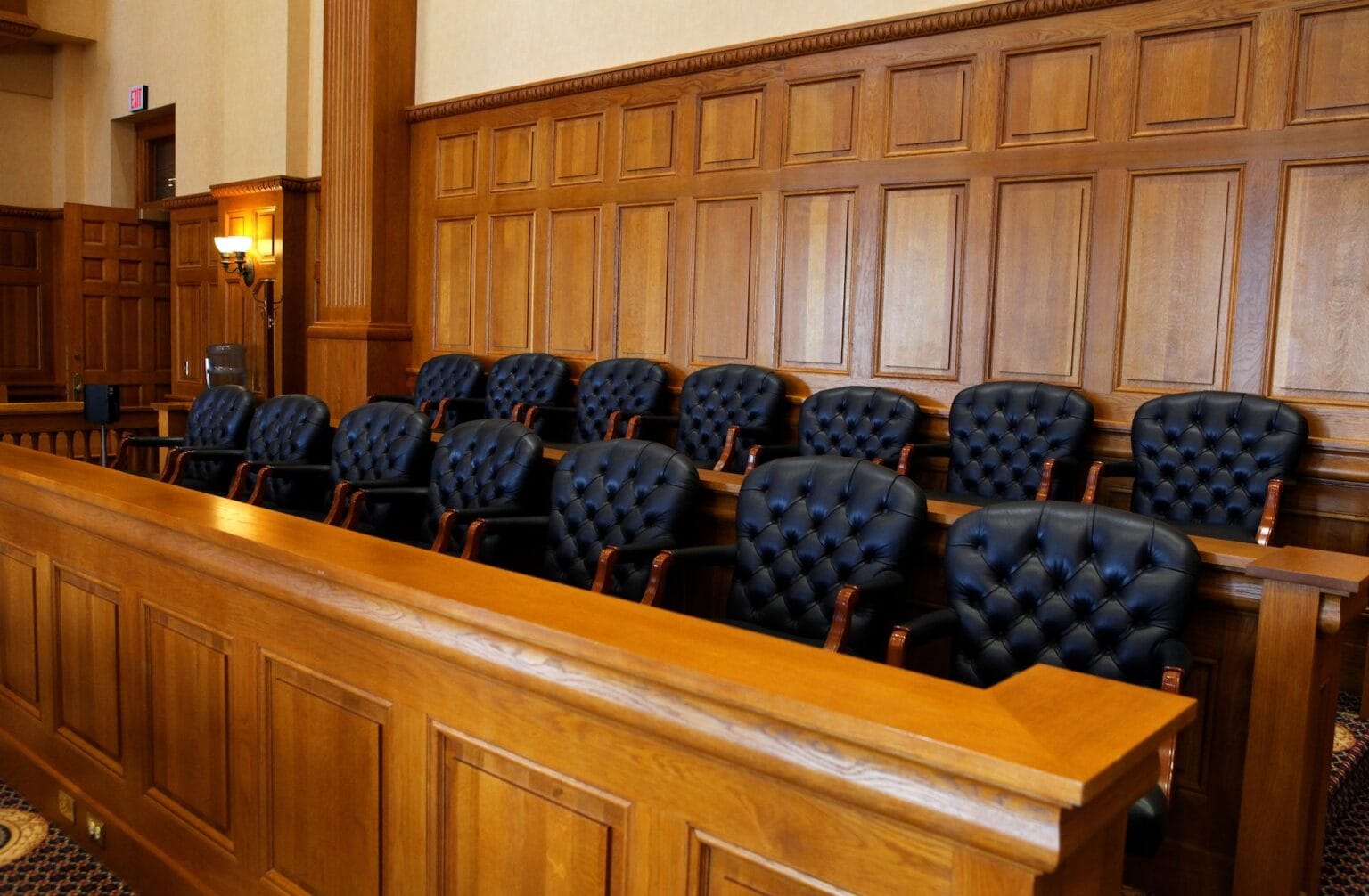 An empty wooden jury box in a courtroom.