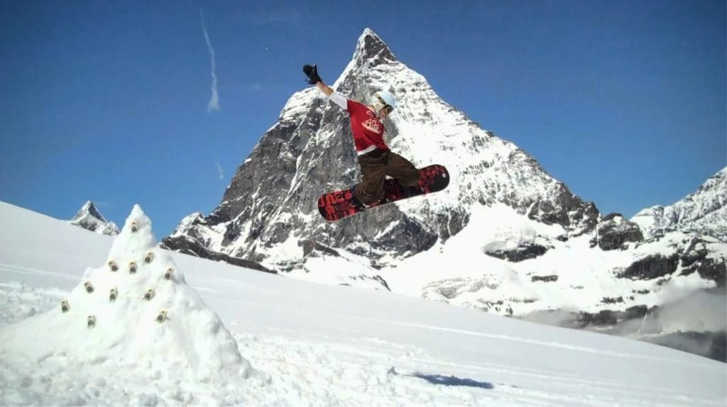 Photo of the author, Jonathan Ronzio, doing a jump on a snowboard in  the Alps.
