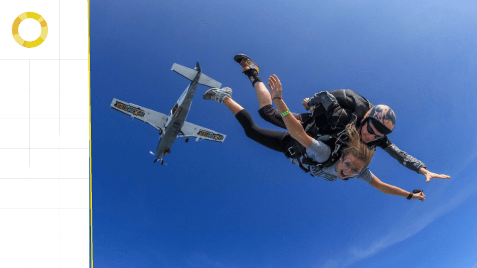 Photo-realistic image of a man and a woman tandem skydiving