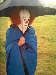 Tim Curry as Pennywise holding an umbrella and blasting a ciggy between takes of 1990's IT.