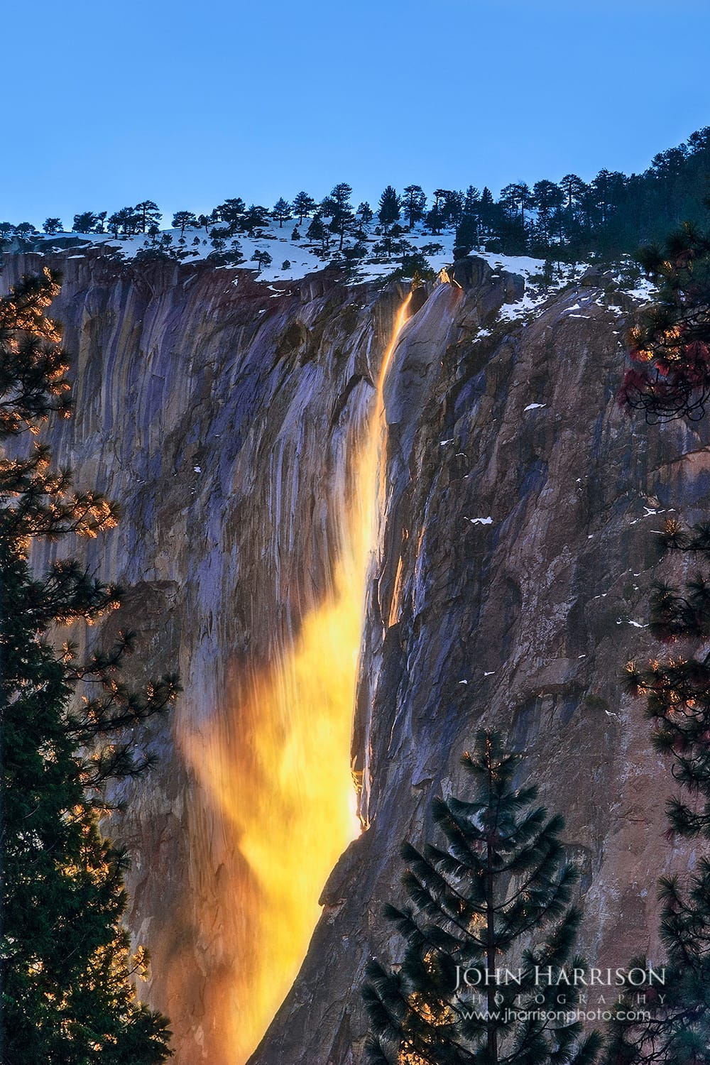 Horsetail Fall glowing orange at sunset on El Capitan during the Yosemite Firefall in Yosemite National Park